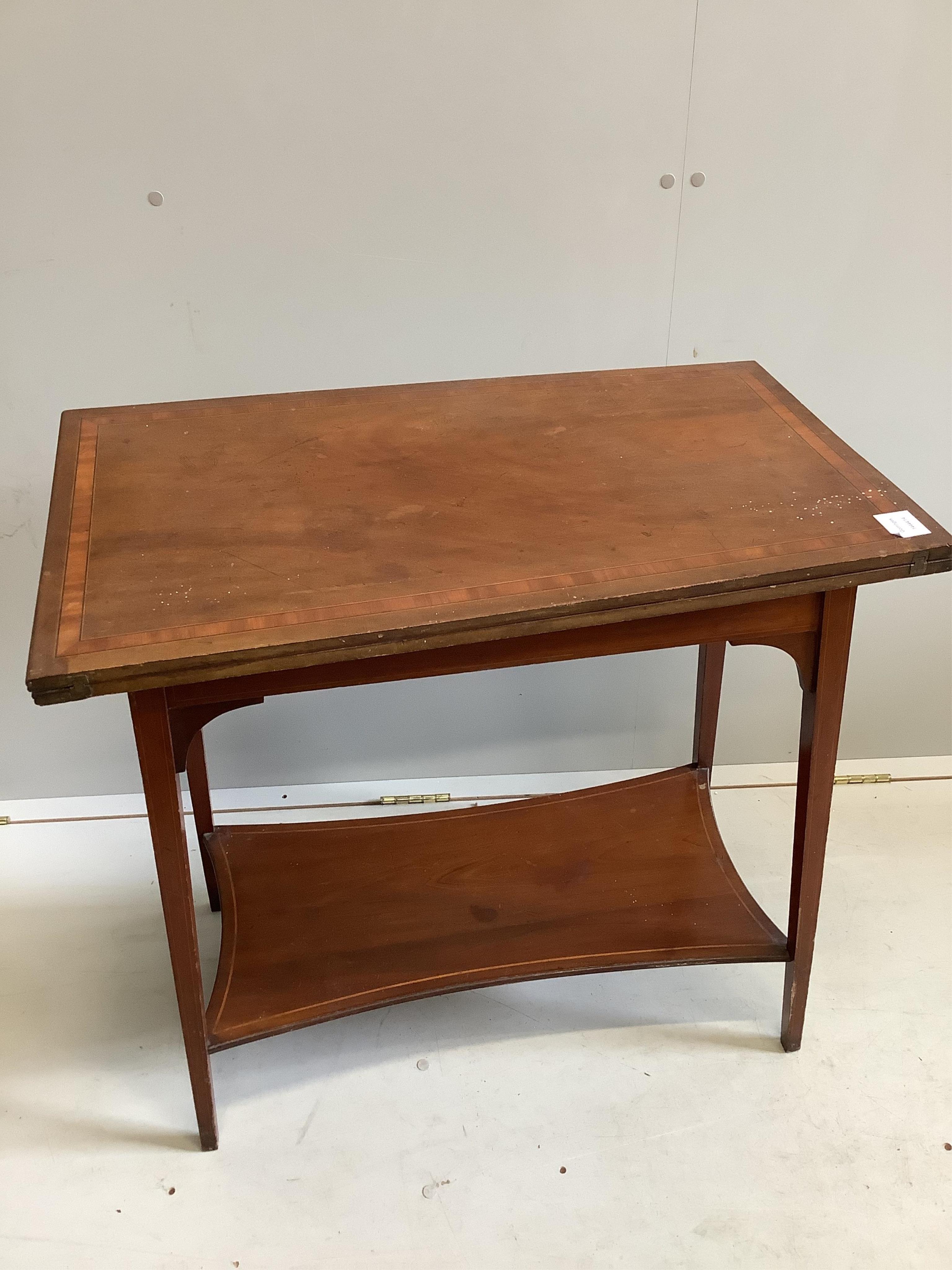 An Edwardian satinwood banded mahogany rectangular folding tea table, width 75cm, depth 42cm, height 73cm. Condition - poor